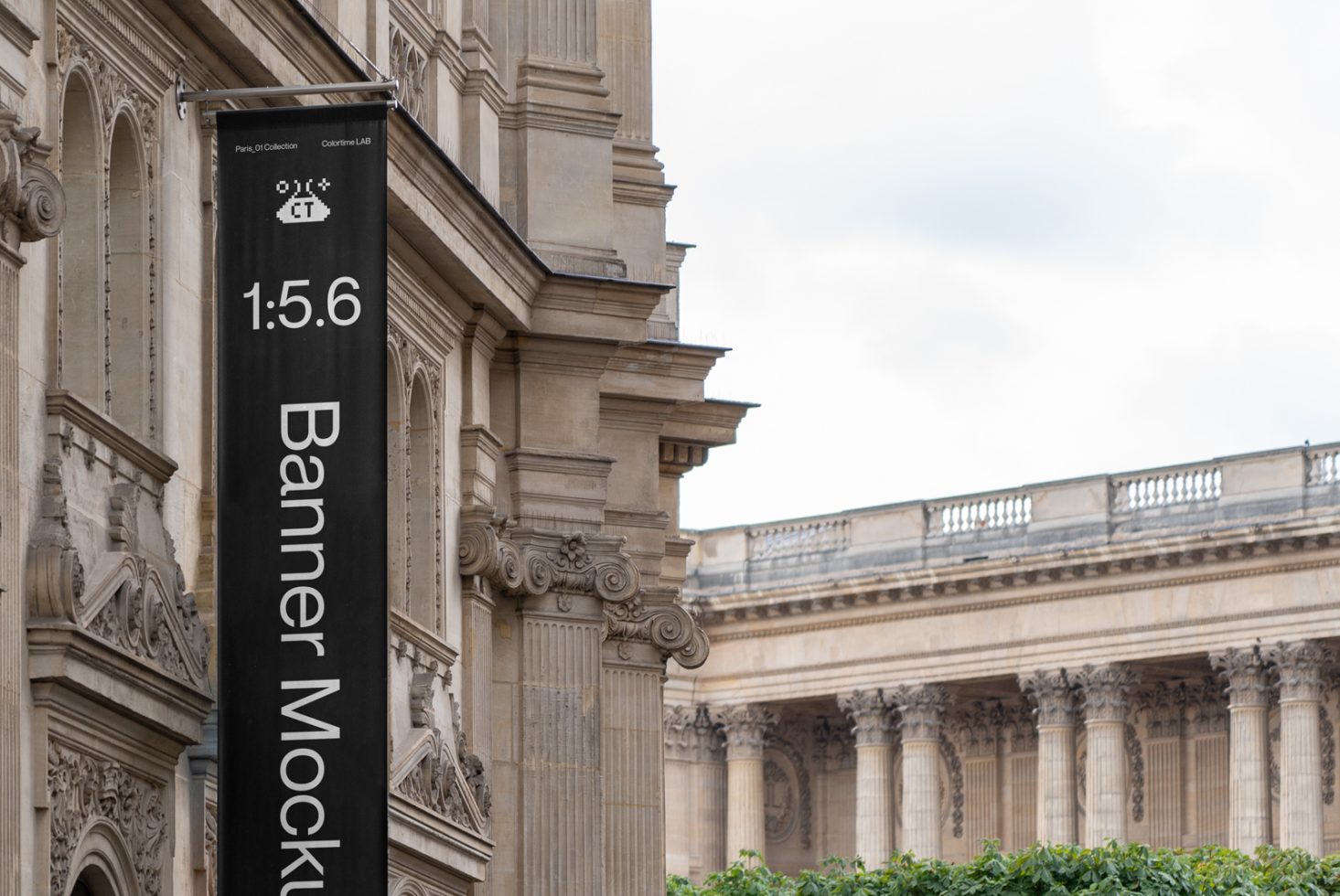 Vertical banner mockup on classic building façade for outdoor advertising design presentation, clear sky, and urban environment.